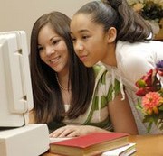 Two girls looking at a computer screen.